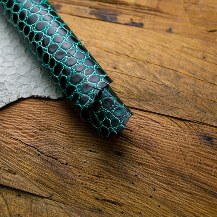 teal and black crocodile embossed leather